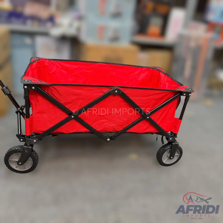 Red foldable utility wagon with black frame and wheels.