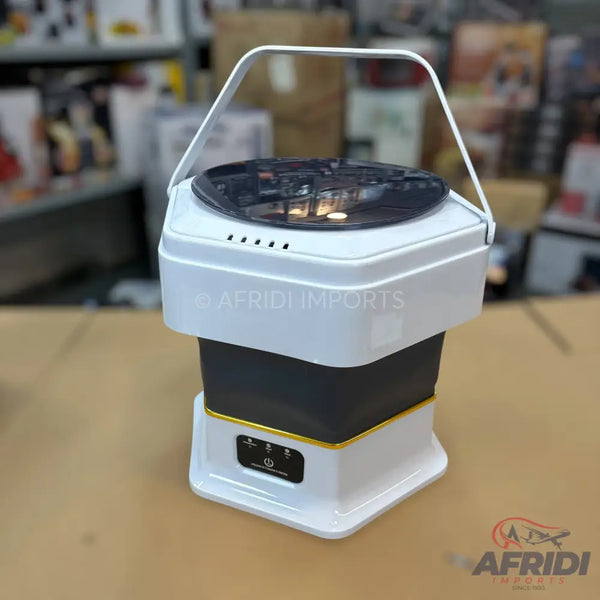 White and black collapsible portable washing machine with a clear lid and a carrying handle.