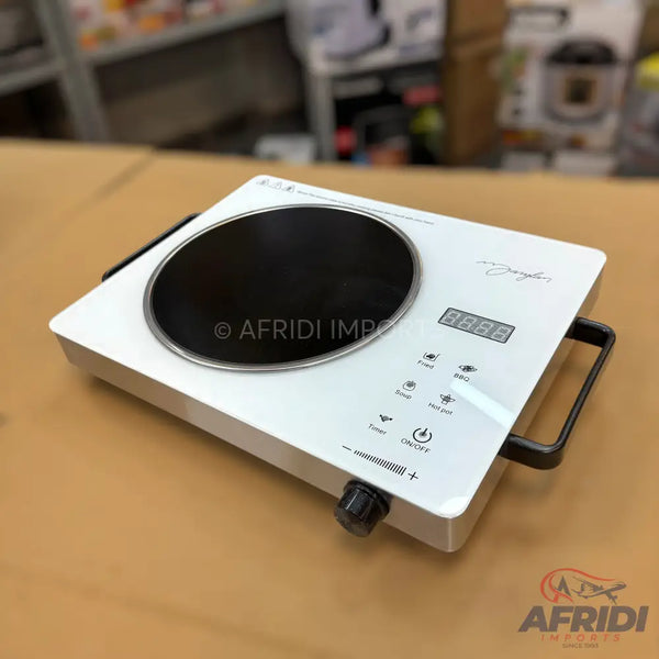 White portable induction cooktop with a black cooking surface, digital display, control buttons, and a rotary knob.