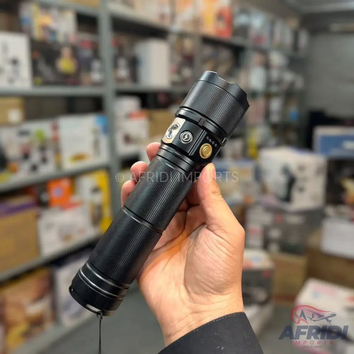 A black, tactical-style flashlight with multiple buttons and textured grip.