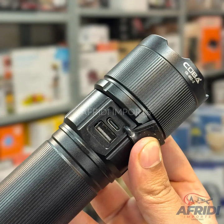 Black, rechargeable LED flashlight with USB-A and USB-C ports.