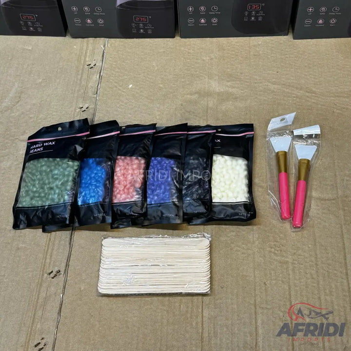 A set of depilatory hard wax beans in various colors, with applicators and spatulas.