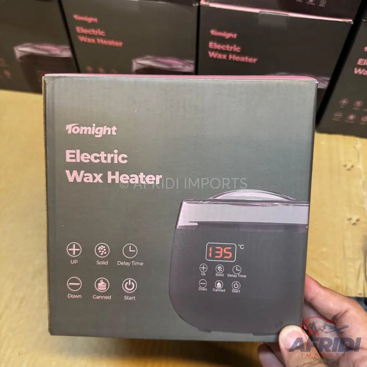A ’Tomnight Electric Wax Heater’ in its packaging, featuring a digital display and control buttons.
