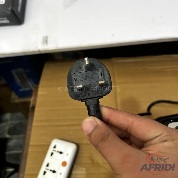Black three-pin UK-style electrical plug with a fuse.