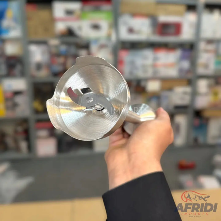 A shiny silver immersion blender with a two-pronged blade.