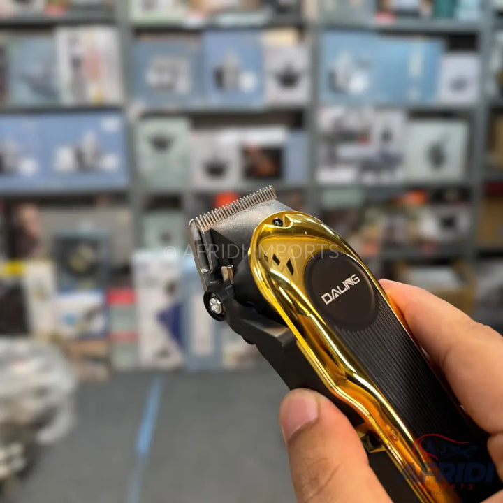 Black and gold electric hair clipper.