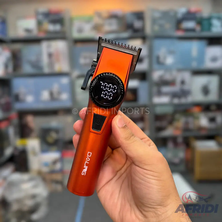 An orange hair clipper with a digital display.