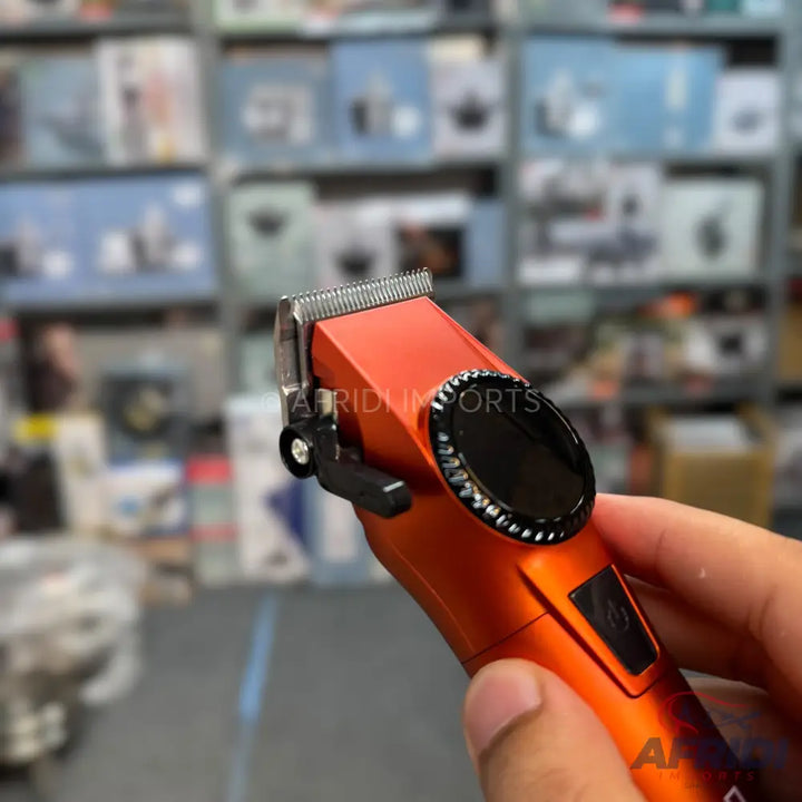 Orange and silver electric hair clipper.