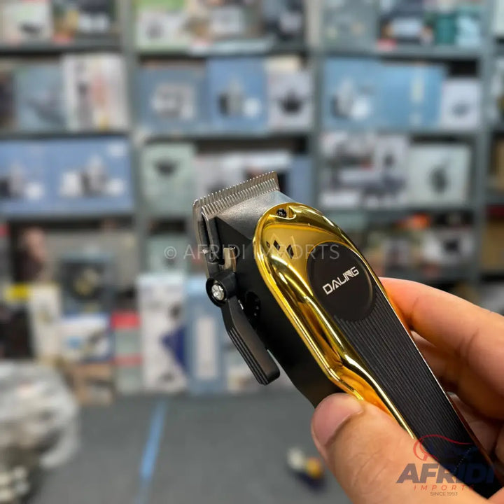 Black and gold electric hair clipper with an adjustable blade.