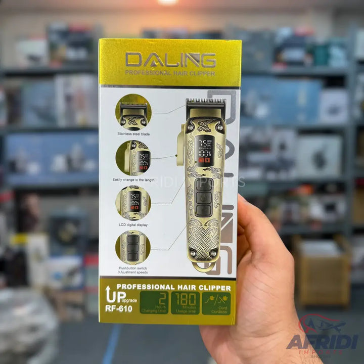 Gold-colored professional hair clipper with an LCD display.
