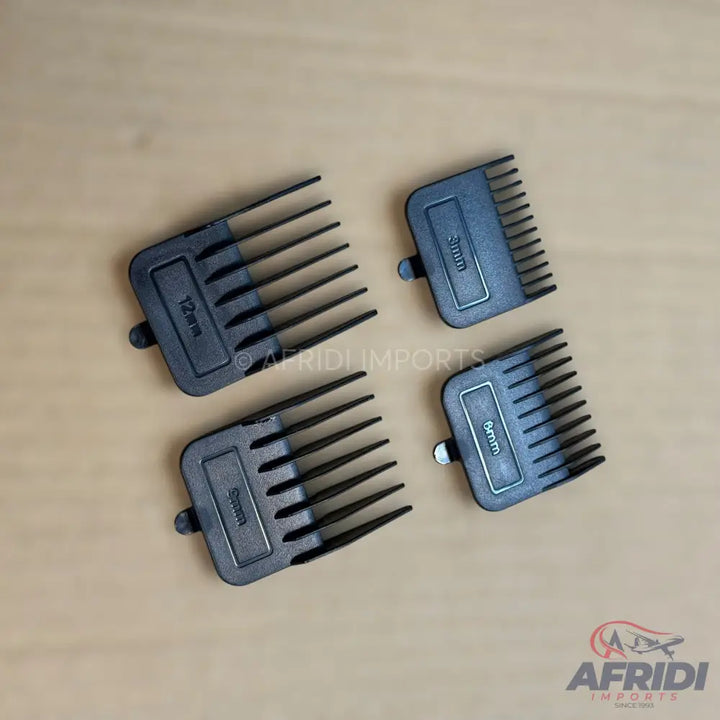 A set of four black plastic hair clipper guide combs of varying lengths.