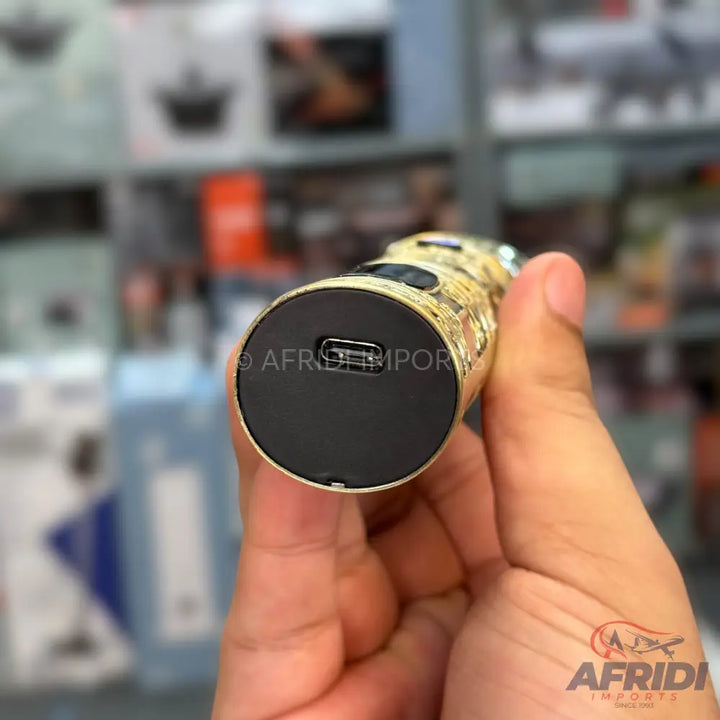 A gold-colored electric trimmer with a USB charging port.