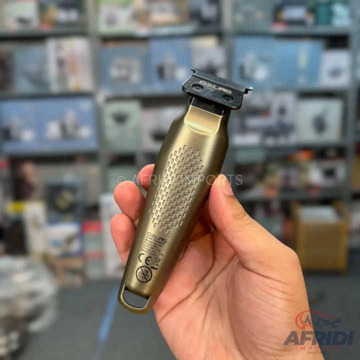 A bronze-colored electric hair trimmer with a textured grip.