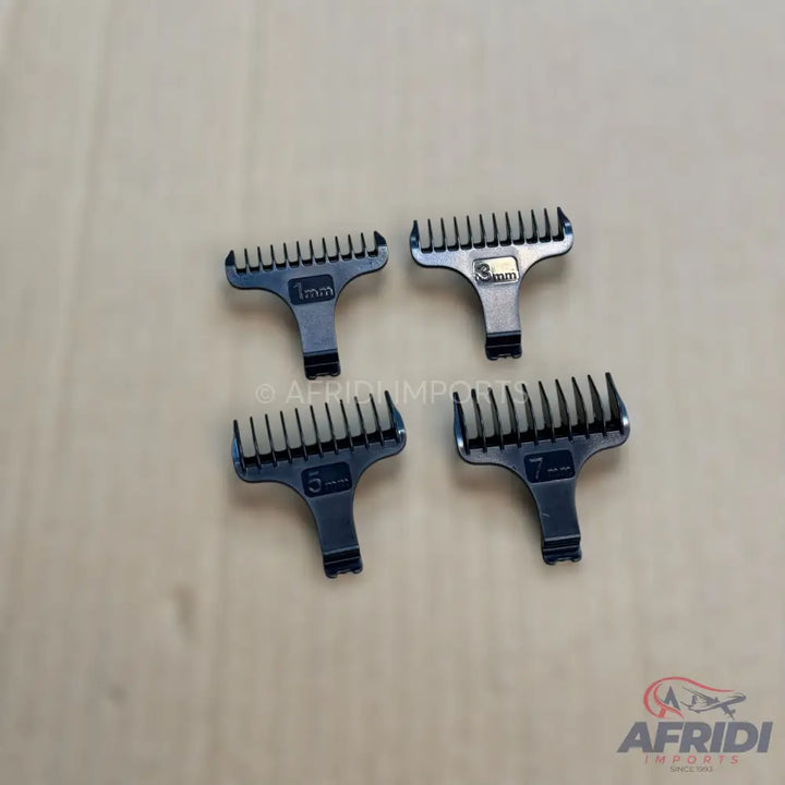 A set of four dark-colored hair clipper guide combs of varying lengths.