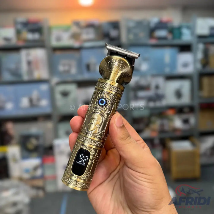 Ornate gold-colored electric hair clipper with an LED display.