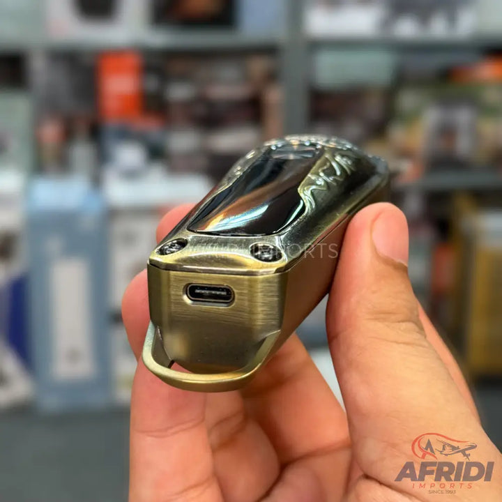 Bronze-colored, decorative electric hair clipper with a USB-C charging port.