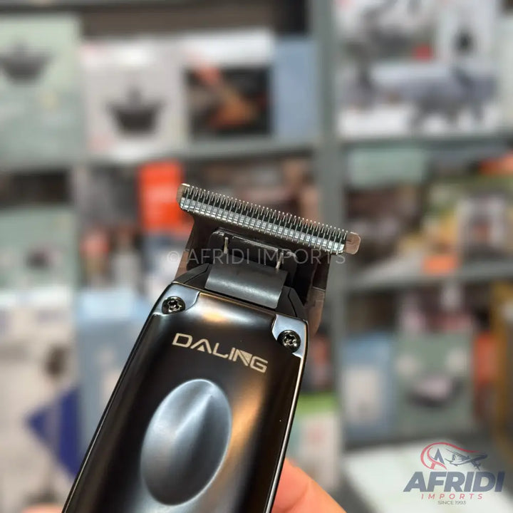 Black metallic hair trimmer with a sharp blade.