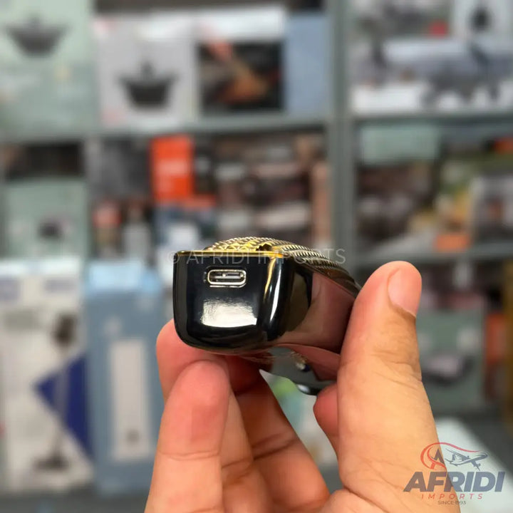 A black portable electric shaver with a USB-C charging port.