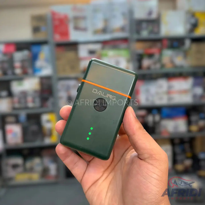 Handheld green electric shaver with an orange accent and three indicator lights.