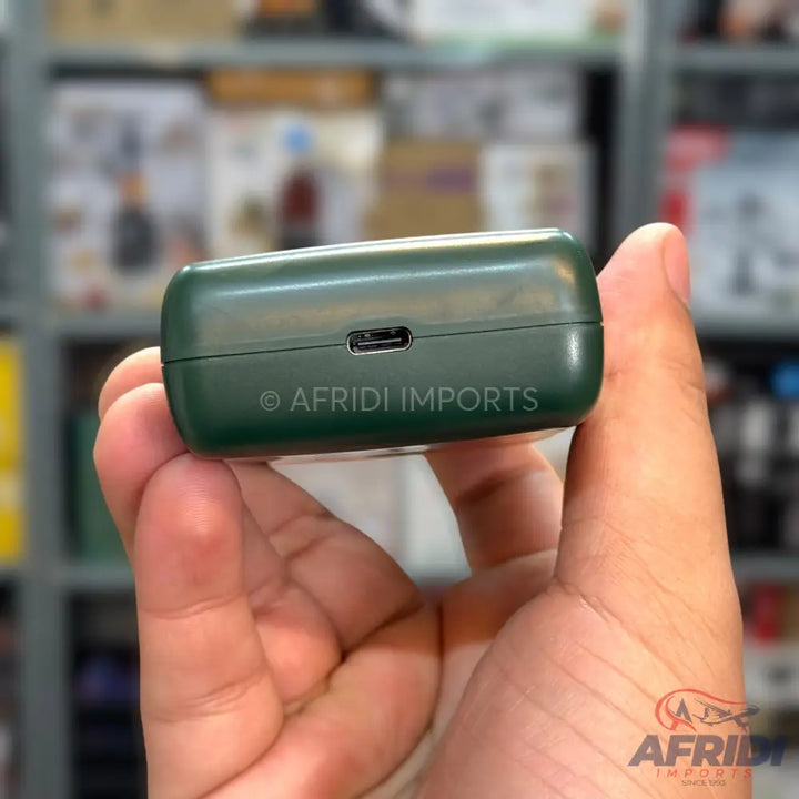 A dark green wireless earbud charging case with a USB-C port.
