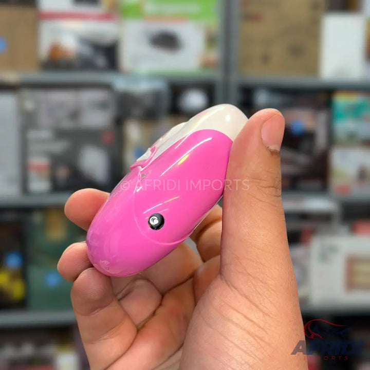 Pink and white tear-drop shaped electronic device with a small black button.