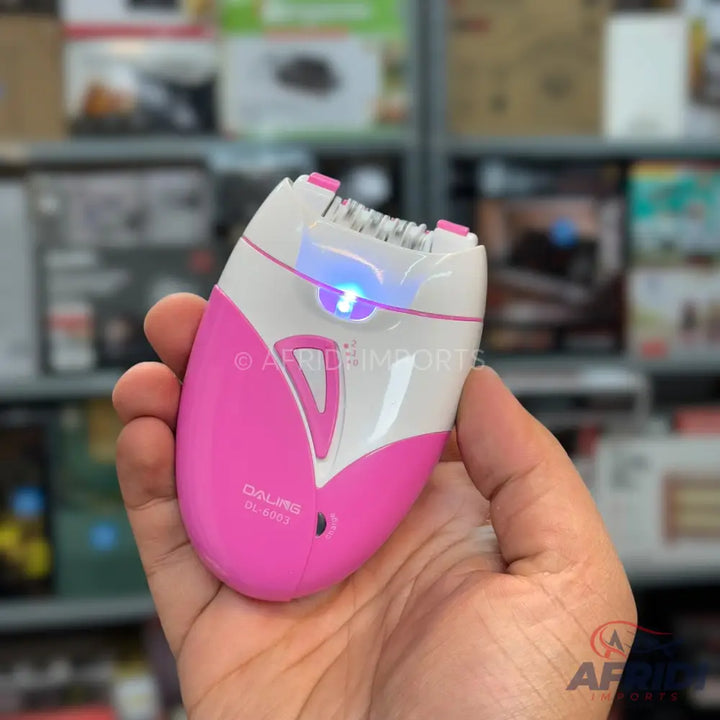 Pink and white electric epilator with a blue LED light.