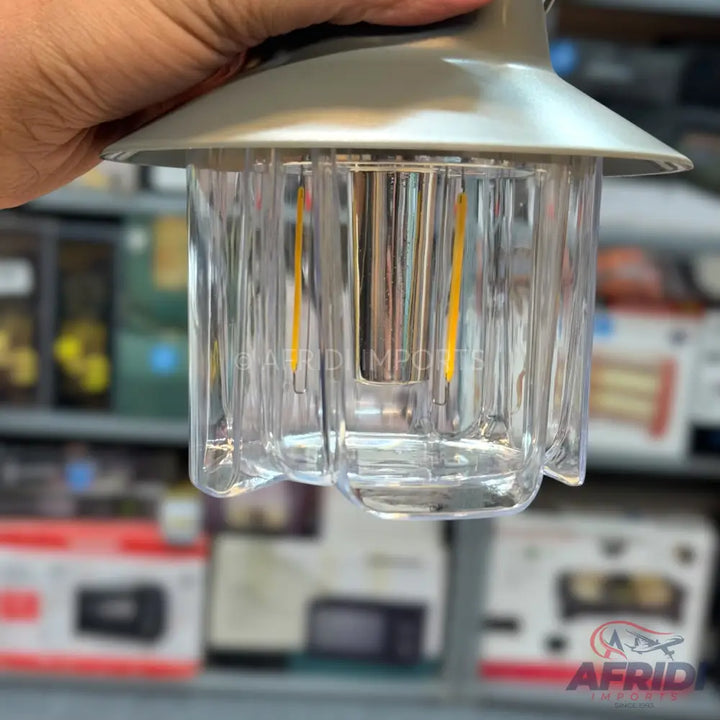 A clear plastic LED lantern with a gray top, designed for portable illumination.
