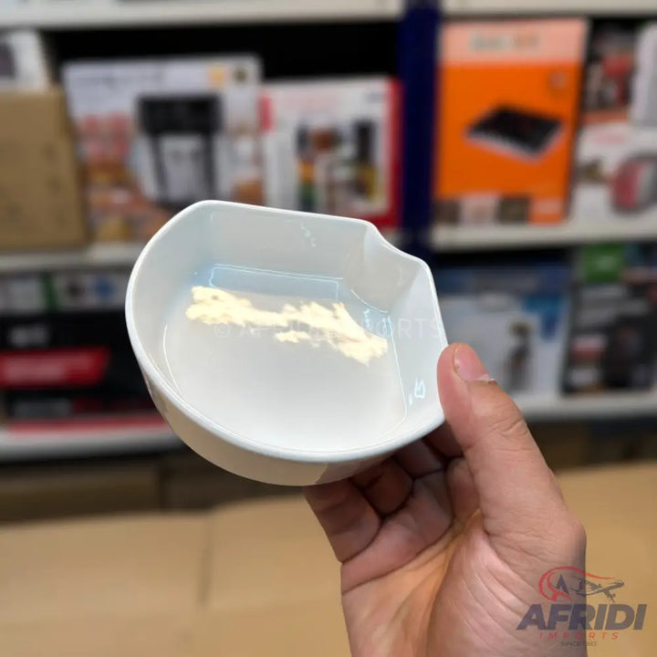 White plastic pet food or water bowl with a raised internal design.