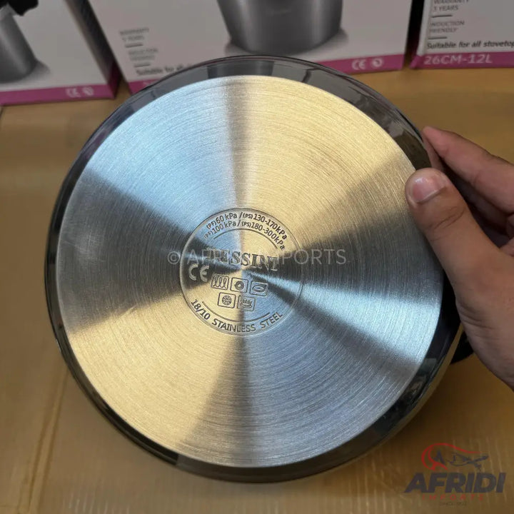 Stainless steel pressure cooker with an induction-compatible base.