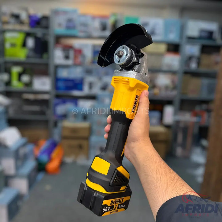 Cordless yellow and black angle grinder with a battery.