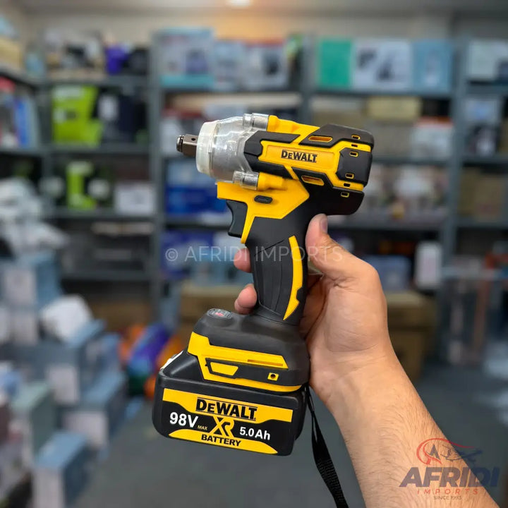 Cordless yellow and black impact wrench with a battery pack.