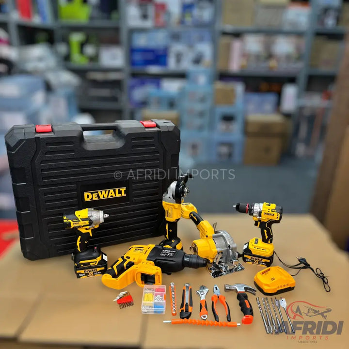 A collection of yellow and black power tools, including drills, an impact driver, an angle grinder, and a circular saw, along with a black carrying case, batteries, a charger, and various hand tools and accessories.