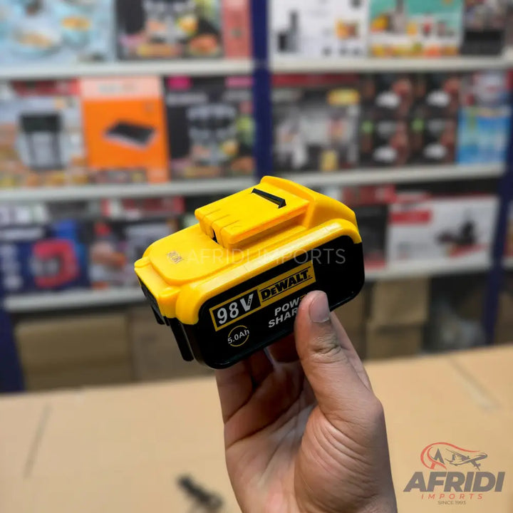 A yellow and black power tool battery.