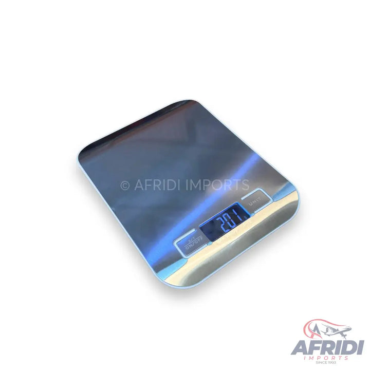 A rectangular digital kitchen scale with a reflective, metallic surface and an illuminated display showing ’20.1’’.