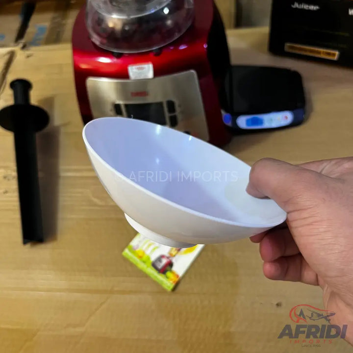 A white plastic measuring scoop with a handle.