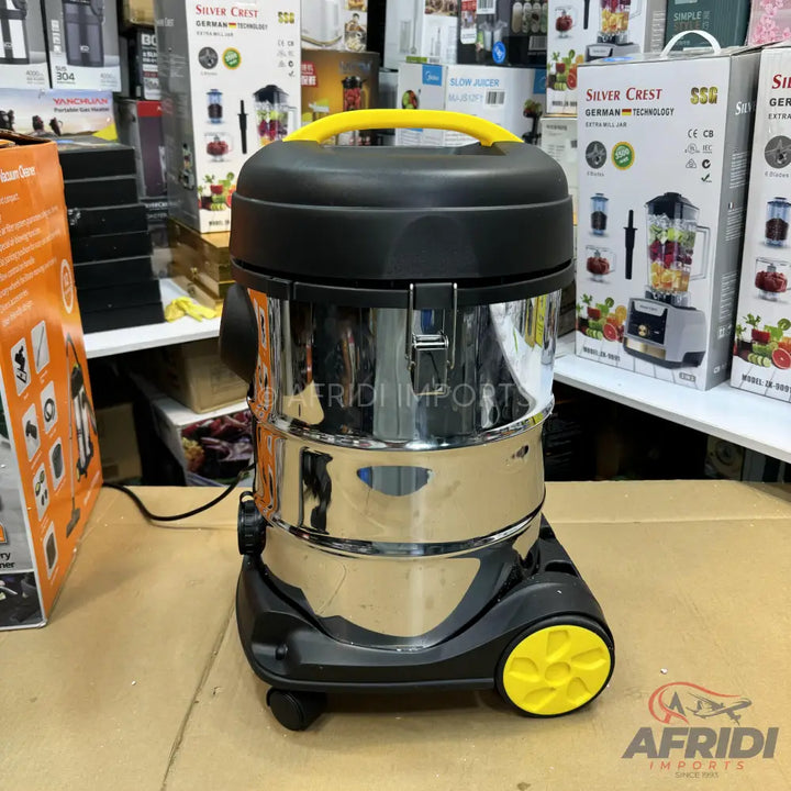 Stainless steel wet/dry vacuum cleaner with a black top and yellow handle and wheels.