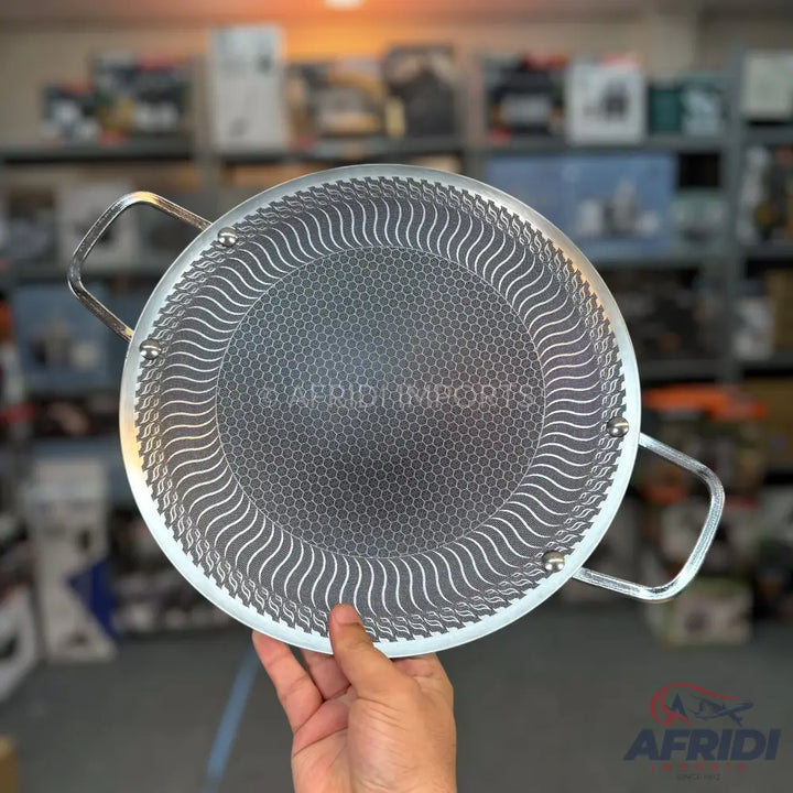 Silver non-stick frying pan with a honeycomb pattern and two handles.