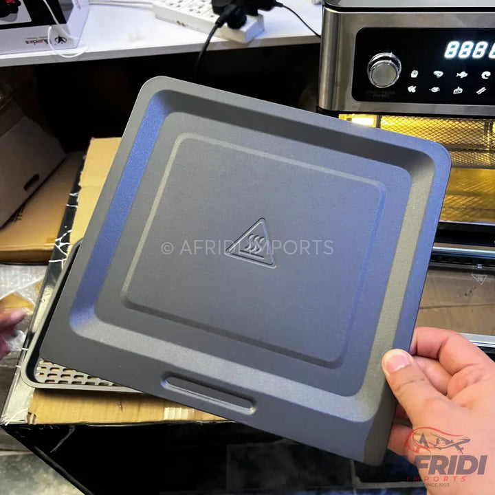 Gray square air fryer baking pan with a raised hot surface symbol.