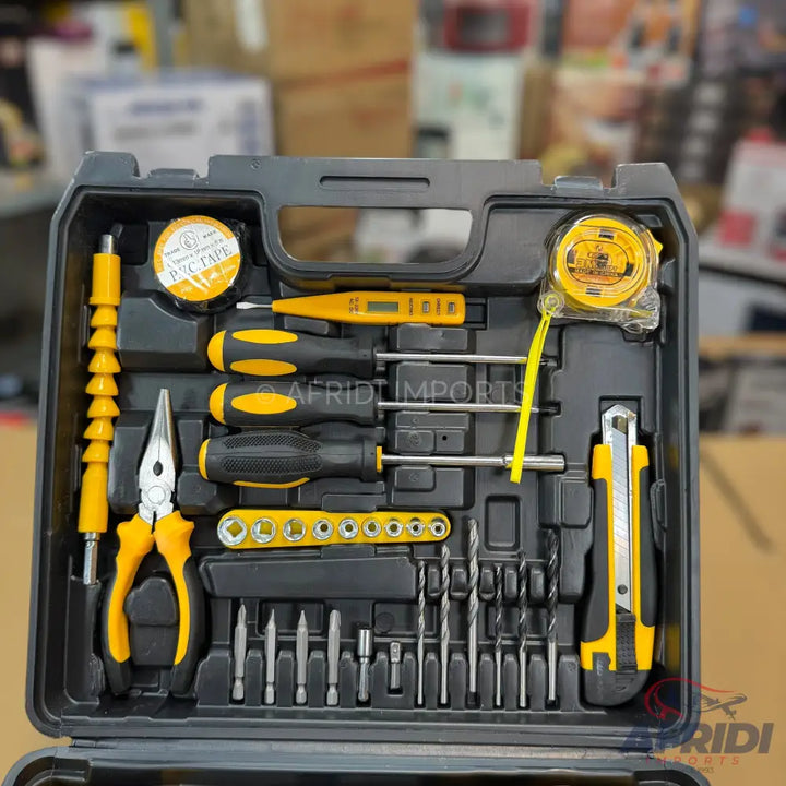 A black and yellow multi-purpose tool kit containing various screwdrivers, drill bits, pliers, a tape measure, and a utility knife.