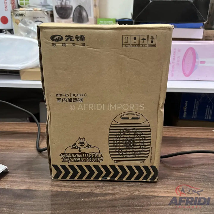 A cardboard box containing a portable electric heater.
