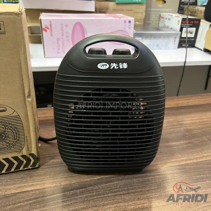 Black portable electric space heater with a handle and two control knobs.