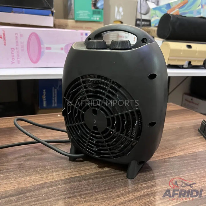 Black electric fan heater with a carry handle and two control knobs.