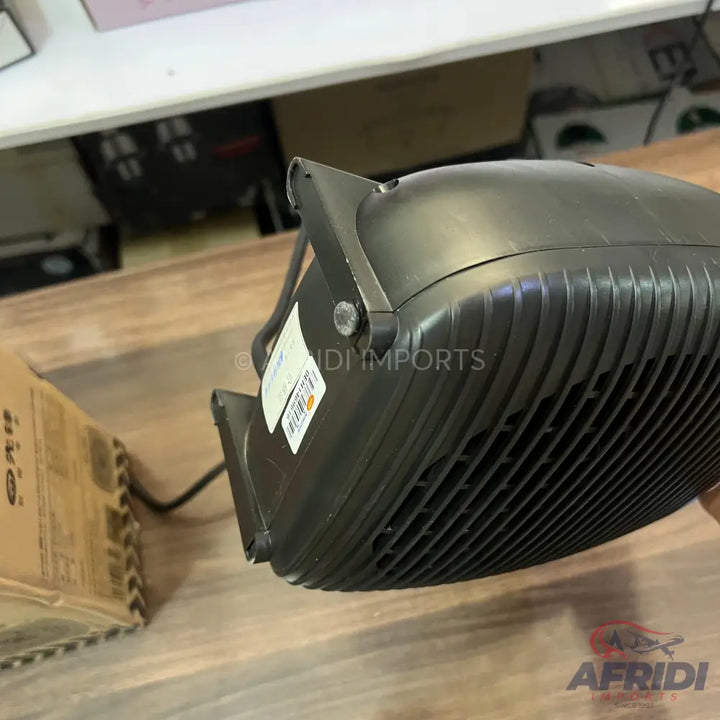 Black outdoor LED floodlight with a finned heat sink.