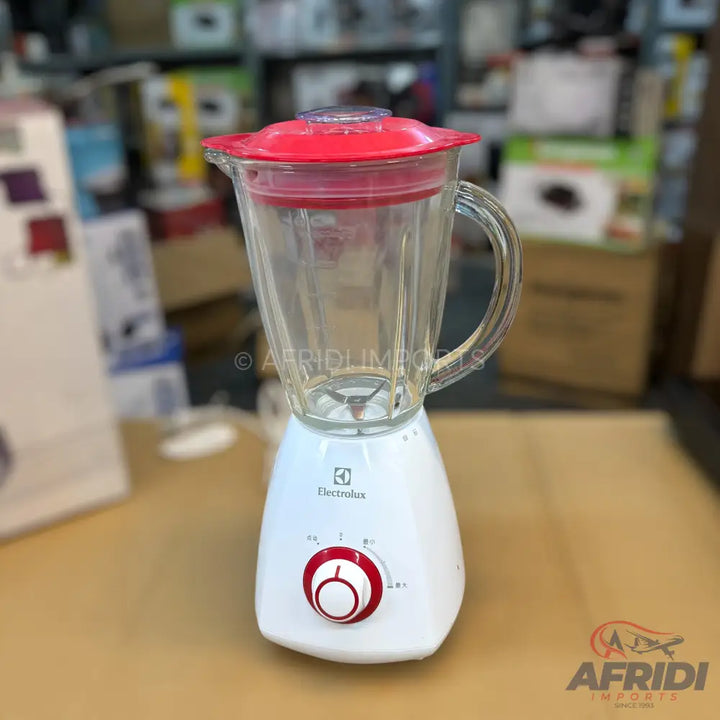 A white Electrolux blender with a clear glass pitcher and a red lid.