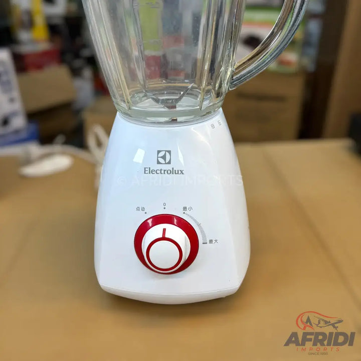 A white Electrolux blender with a glass pitcher and a red control dial.