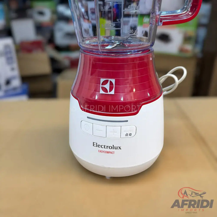 Red and white Electrolux blender with a clear pitcher.