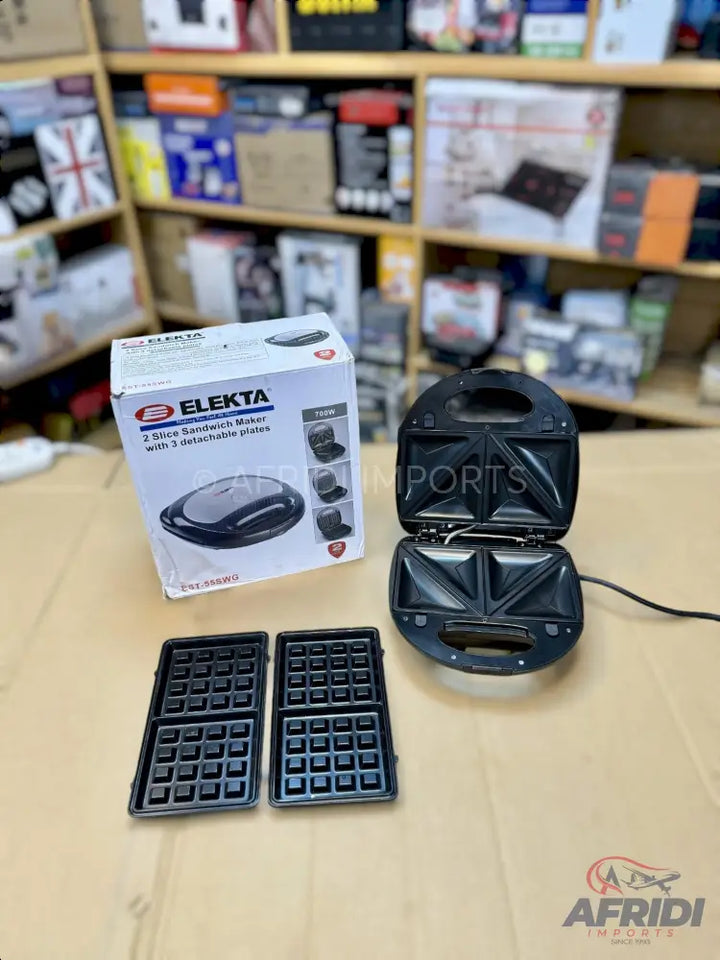 A black, two-slice sandwich maker with interchangeable waffle plates.