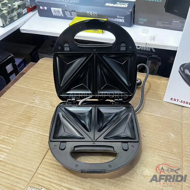 Open black sandwich maker with triangular cooking plates.