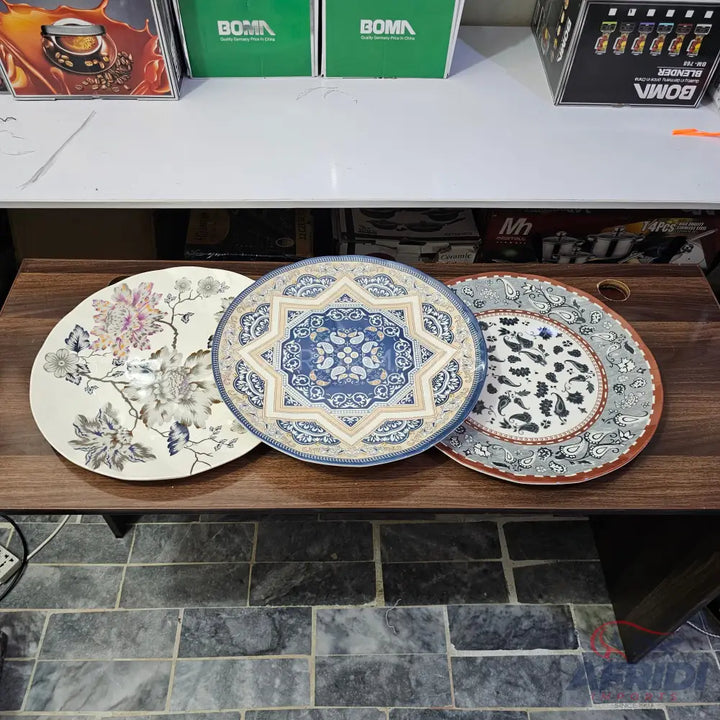 Three decorative dinner plates with distinct patterns.