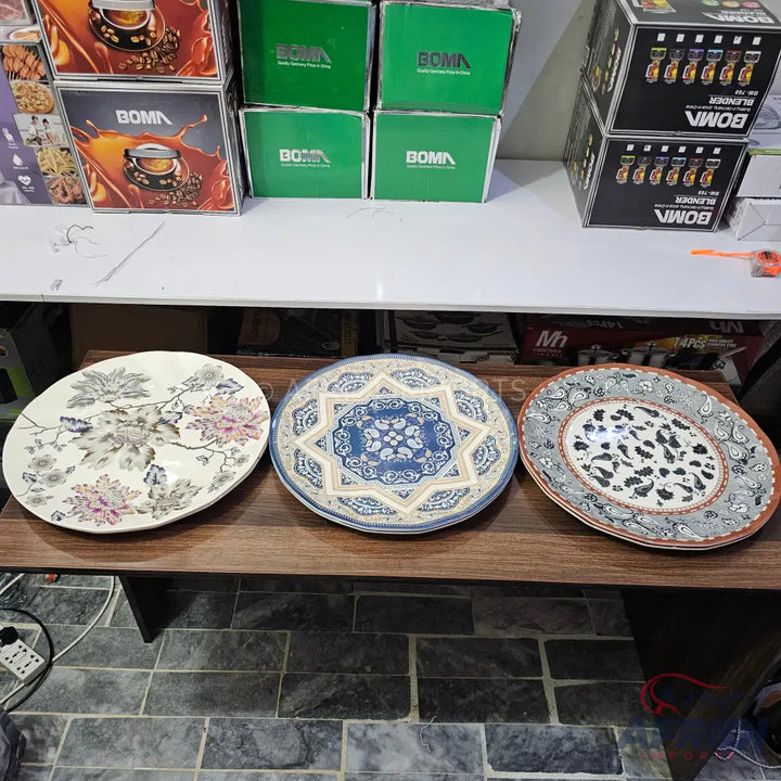 Three decorative ceramic plates with diverse patterns.